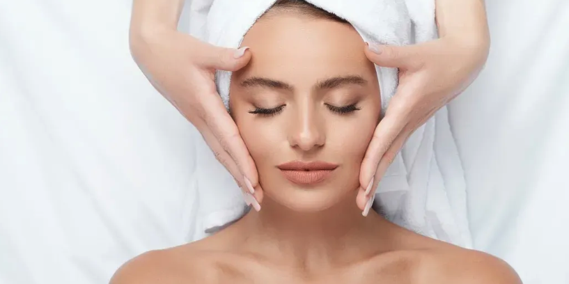 Woman receiving facial treatment